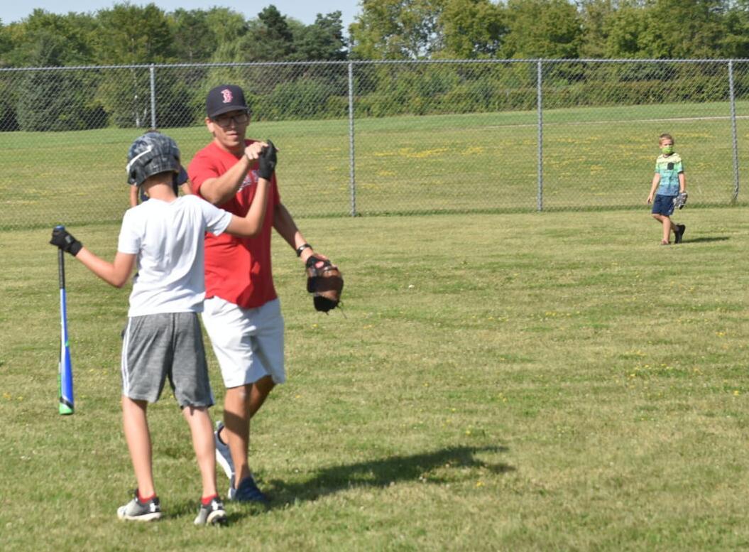 Alexander Corkins high fives his coach with a gloved hand